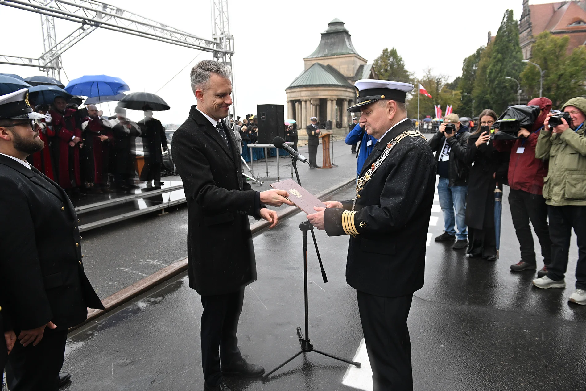 Wiceminister Infrastruktury Arkadiusz Marchewka przekazuje Rektorowi PM Wojciechowi Ślączce dokument z uchwałą Rady Ministrów