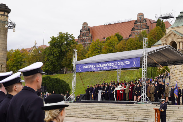 Guests in the grandstand with the MUS building in the background during the academic year opening ceremony