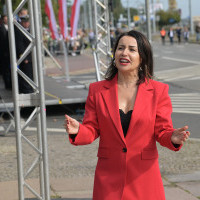 Dyrygentka Chóru PM Sylwia Fabiańczyk-Makuch dyryguje chórem podczas uroczystości inauguracji nowego roku akademickiego 2023/24 na PM