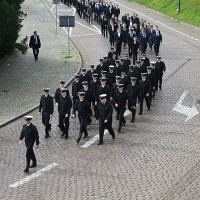 Studenci I roku Politechniki Morskiej w Szczecinie schodzą ulicą u stóp Wałów Chrobrego na uroczystość inauguracji roku akademickiego