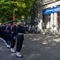 Kompania Honorowa PM z pocztem sztandarowym i dowódcą oraz pracownicy PM podczas uroczystości podniesienia bandery przy budynku uczelni z okazji Święta Szkoły 
