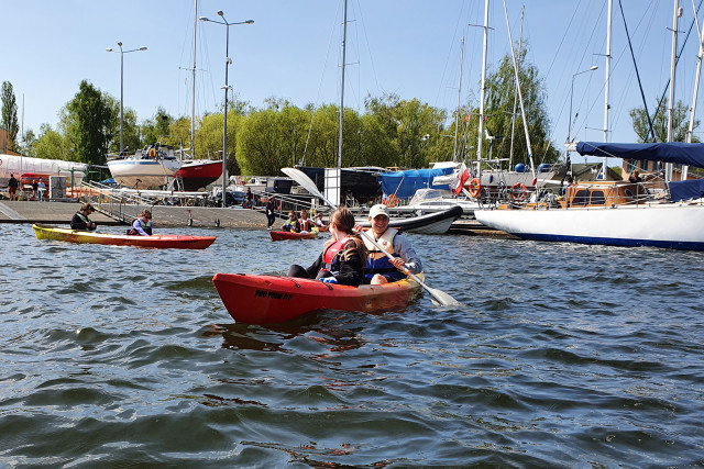 Cleaning the shores of Lake Dabie in a kayak.